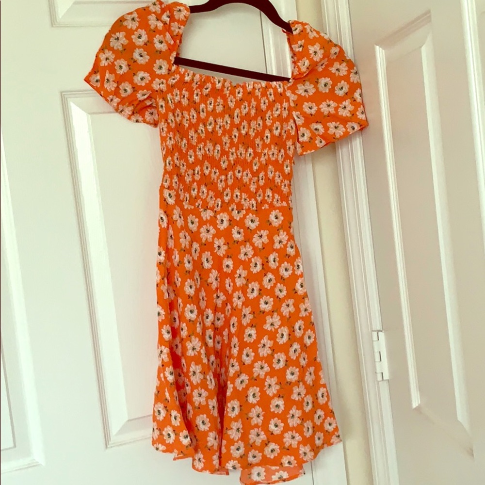Orange dress with flower print on it